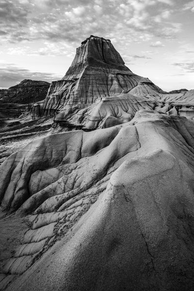 Black and white pyramid shaped formation with textured ridges in front.